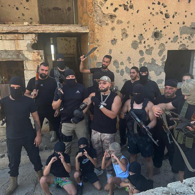 Behind the scenes … the music video crew take time out from posing with firearms to pose with firearms in this picture Younes posted to social media. Picture: Instagram