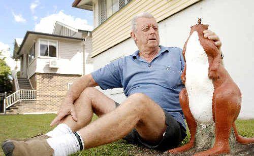 An upset Norm Clapham of Dawson Street in Lismore looks forlornly at his 30-year-old kangaroo statue that was recently decapitated by vandals. Picture:  DAVID NIELSEN