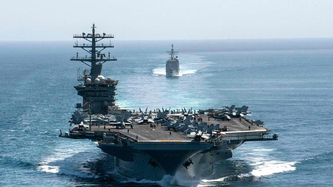 US aircraft carrier USS Nimitz and the guided-missile cruiser USS Philippine Sea in formation during a Strait of Hormuz transit in 2020. (Photo by elliot Schaudt / US NAVY / AFP)