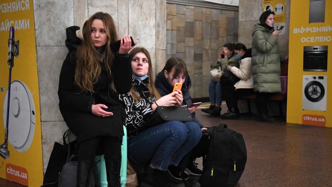 Girls take refuge in a metro station in Kyiv. Picture: Daniel Leal / AFP