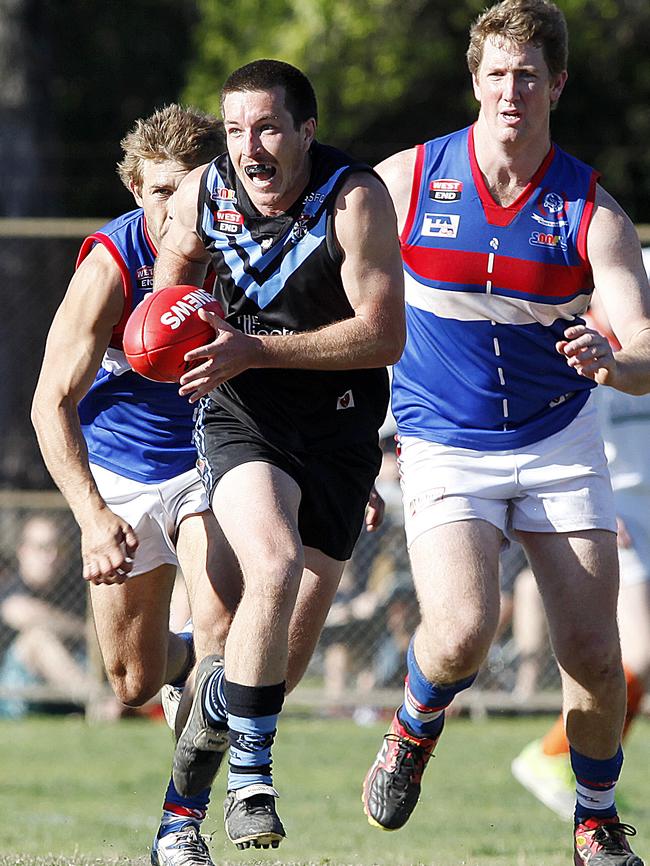 Blackfriars Old Scholars player Brad Hillman makes a run for it during the Hounds’ 2014 grand final win over Rosewater. Picture: Bianca De Marchi