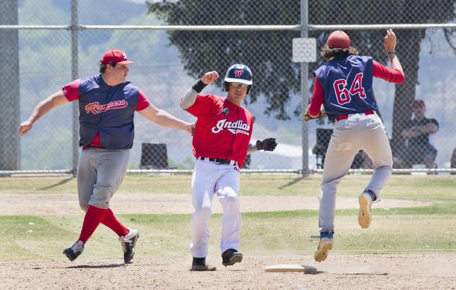 Taewoo Kim, Indians tagged out by pitcher Lawrence Taylor.