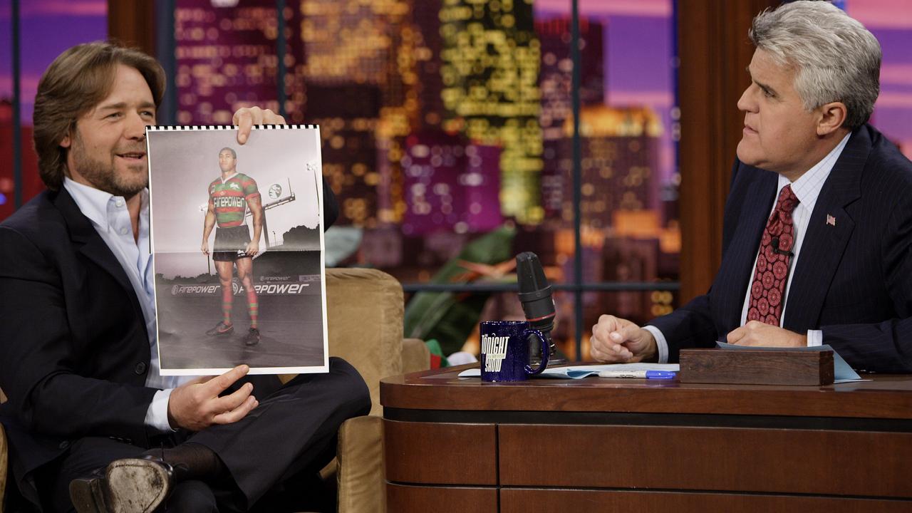 Russell Crowe showing off a Rabbitohs jersey with Firepower sponsorship during an interview with Jay Leno on the Tonight Show. Picture: Paul Drinkwater/Getty Images