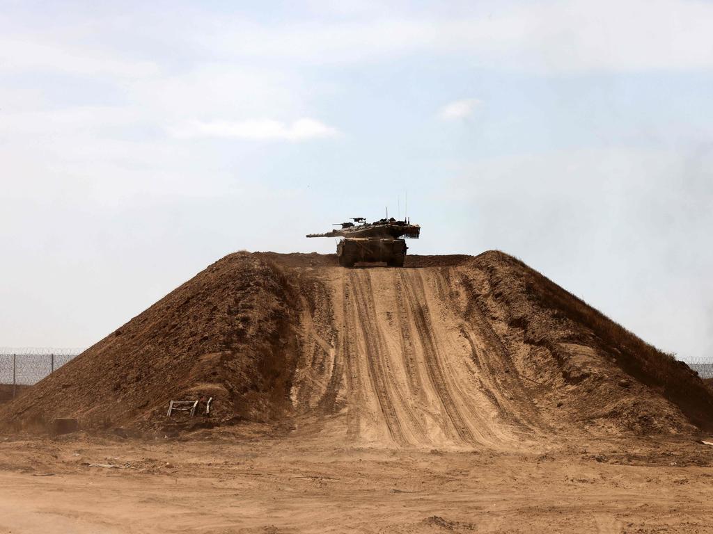 An Israeli tank is stationed atop a sand mound near the border with the Gaza Strip on May 2, 2024, amid the ongoing conflict in the Palestinian territory between Israel and the militant group Hamas. Picture: AFP