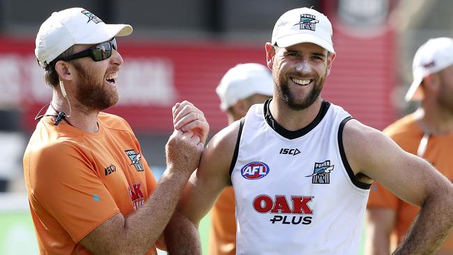 Matthew Broadbent (R) having a laugh with Power assistant coach Trent Henschal during a Port training session earlier this year. Broadbent will line up in the SANFL with South Adelaide in 2020 after the Power delisted him. Picture: Sarah Reed