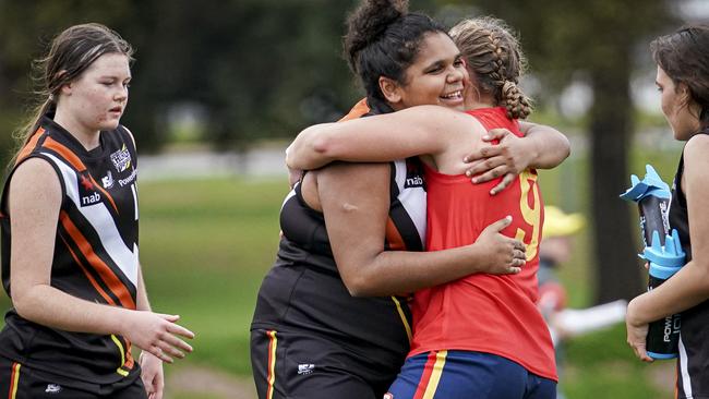 NT’s Molly Althouse hugs SA’s Jaimi Tabb during the AFLW under-18 championships. Picture: AAP/MIKE BURTON