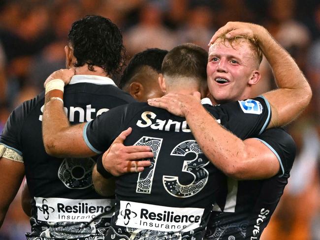 Players from the Waratahs react after winning the Super Rugby Round 3 match between New South Wales Waratahs and Fijian Drua at Allianz Stadium in Sydney on February 28, 2025. (Photo by SAEED KHAN / AFP) / -- IMAGE RESTRICTED TO EDITORIAL USE – STRICTLY NO COMMERCIAL USE --