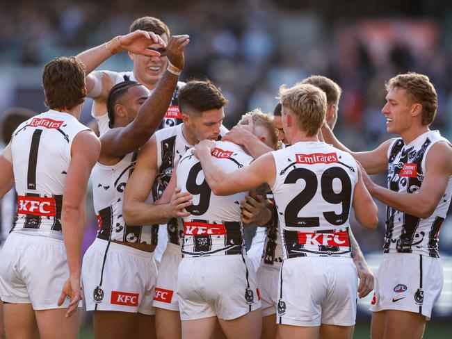 John Noble mobbed by teammates after producing one of the highlights of the day. Picture: Dylan Burns/AFL Photos