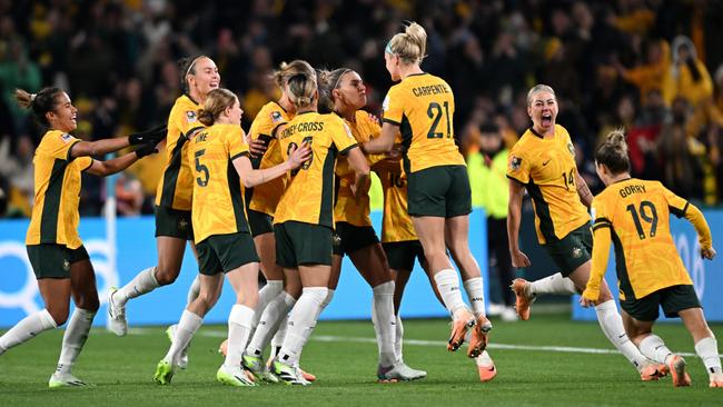 Steph Catley (C) of Australia celebrates with teammates after scoring her team's first goal. (Photo by Bradley Kanaris/Getty Images)