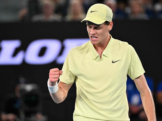 Italy's Jannik Sinner reacts after a point against USA's Ben Shelton during their men's singles semi-final match on day thirteen of the Australian Open tennis tournament in Melbourne on January 24, 2025. (Photo by WILLIAM WEST / AFP) / -- IMAGE RESTRICTED TO EDITORIAL USE - STRICTLY NO COMMERCIAL USE --