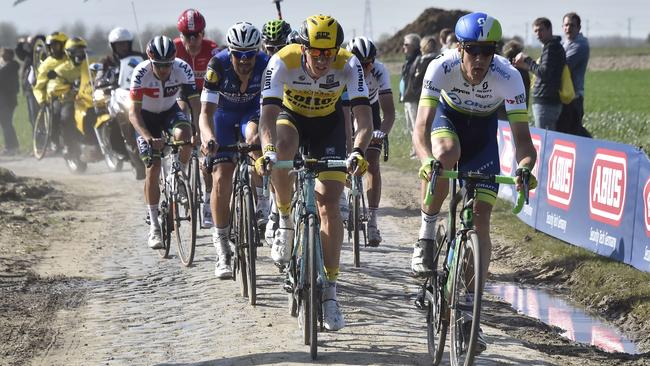 Australia's Mathew Hayman (right) rides on the cobblestones next to Belgium's Sep Vanmarcke (centre) during the Paris-Roubaix one-day classic cycling race.