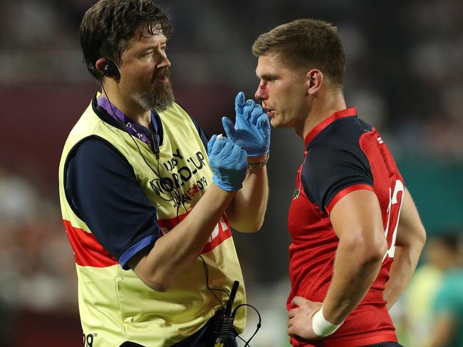 Owen Farrell receives attention from team doctor Rob Young.