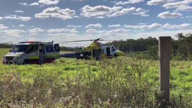 Paramedics attend to man with serious injuries after excavator rollover