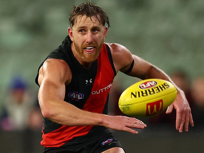 MELBOURNE, AUSTRALIA - JUNE 29: Dyson Heppell of the Bombers kicks during the round 16 AFL match between Geelong Cats and Essendon Bombers at Melbourne Cricket Ground on June 29, 2024 in Melbourne, Australia. (Photo by Graham Denholm/Getty Images)