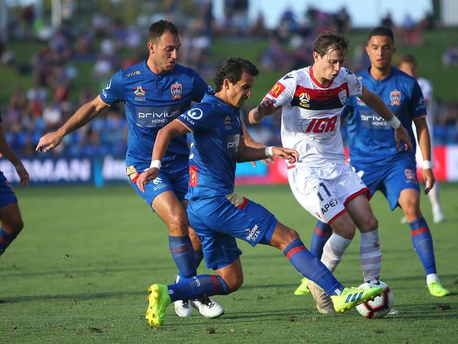 NEWCASTLE, AUSTRALIA - FEBRUARY 24: Craig Goodwin of Adelaide United contests the ball with Daniel Georgievski of Newcastle Jets during the round 20 A-League match between Newcastle Jets FC and Adelaide United at McDonald Jones Stadium on February 24, 2019 in Newcastle, Australia. (Photo by Tony Feder/Getty Images)