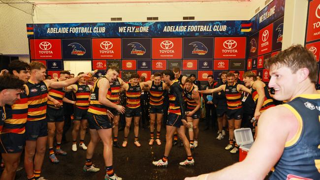 Mark Keane in the middle of the Crows’ song post-Showdown. Picture: Sarah Reed/AFL Photos via Getty Images