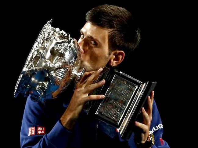 Novak Djokovic of Serbia kisses his trophy after defeating Andy Murray of Britain in the men's singles final at the Australian Open tennis championships in Melbourne, Australia, Sunday, Jan. 31, 2016. Picture: AP Photo - Rafiq Maqbool