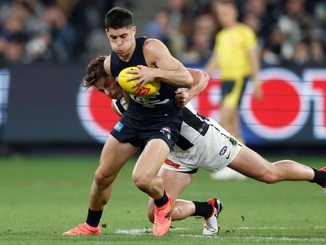 Adam Cerra is tackled by Pat Lipinski. Picture: Michael Willson/AFL Photos via Getty Images