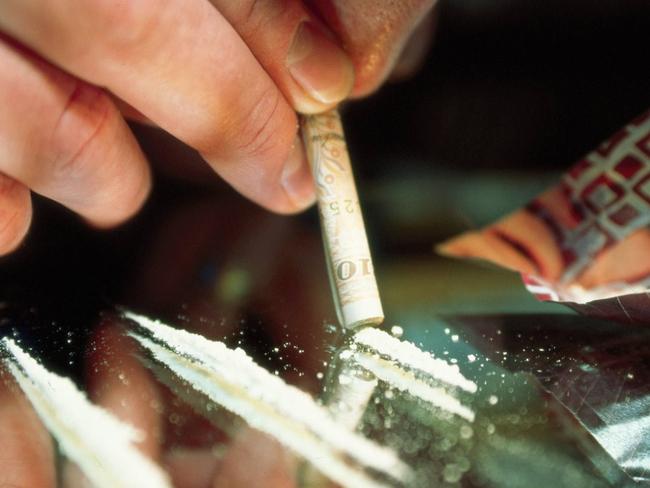 Cocaine being snorted off a mirror on a dinner plate with rolled $50 note. NSW / Drug Use Generic