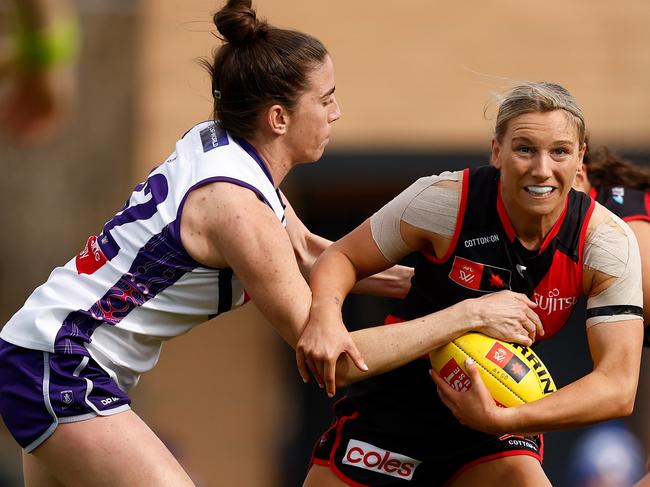 Laura Pugh tries to stop Essendon’s Sophie Van De Heuvel. Picture: Michael Willson/AFL Photos via Getty Images