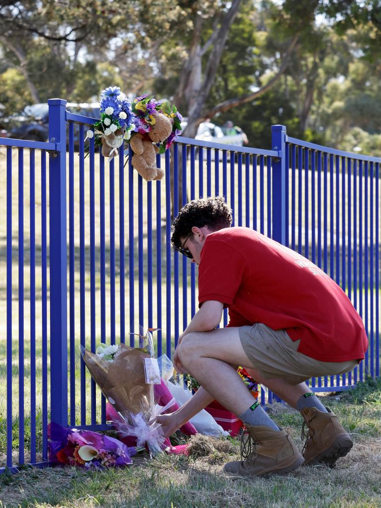 Local Liam Kelly lays flowers. Picture: Grant Viney