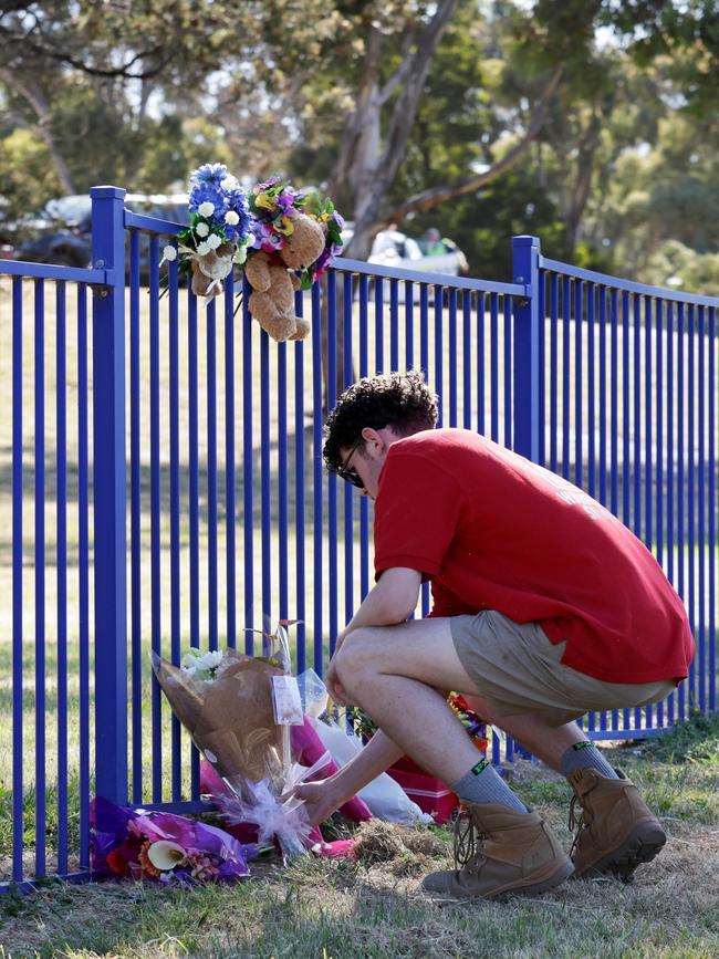 Local Liam Kelly lays flowers. Picture: Grant Viney