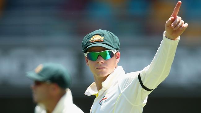 BRISBANE, AUSTRALIA - DECEMBER 17: Australian captain Steve Smith signals to team mates during day one of the 2nd Test match between Australia and India at The Gabba on December 17, 2014 in Brisbane, Australia. (Photo by Cameron Spencer/Getty Images)