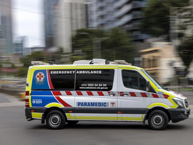 MELBOURNE, AUSTRALIA - NewsWire Photos FEBRUARY 13, 2022: An ambulance speeds away from the Royal Melbourne Hospital. Ambulance, Generic.Picture: NCA NewsWire / David Geraghty