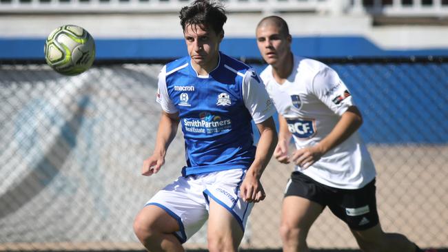 Modbury's Daniel Detroit gets to the ball first ahead of Comets’ Nathan Andijanto during the Jets’ 1-0 win. Picture: AAP/Dean Martin