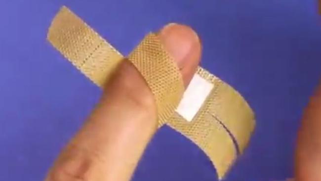 How you should actually be putting on a bandaid, by cutting the ends and crossing them over.