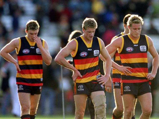 Simon Goodwin, Brett Burton and Kane Johnson after a loss against the Sydney Swans. Kane Johnson has been influential throughout Goodwin’s time coaching the ‘Dees’. Picture: Ray Titus/News Limited