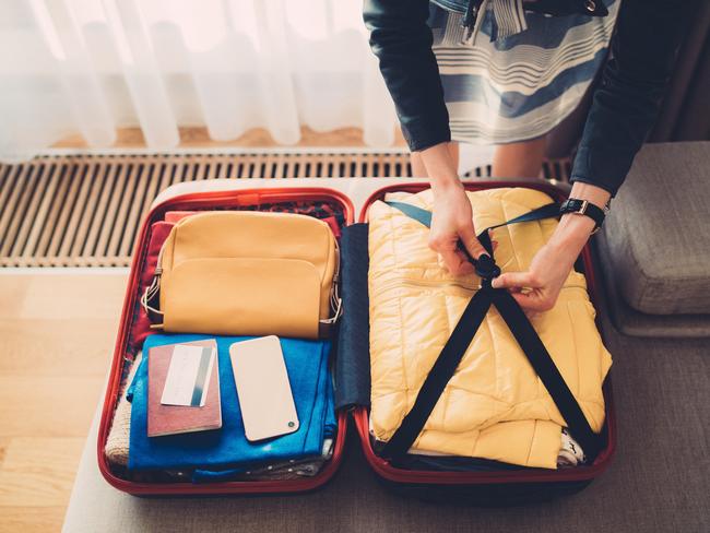 Close-up of woman preparing luggage