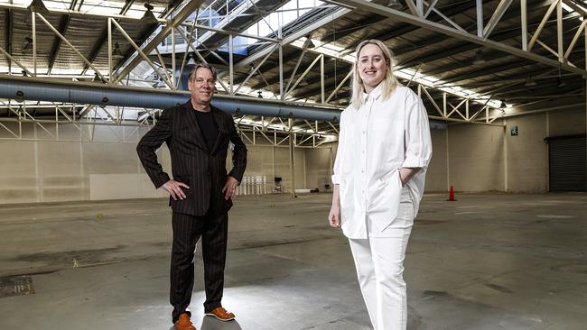 Mona Foma curator Brian Ritchie and Mona curator Emma Pike inside the old K&D Warehouse building which will be turned into an art exhibition space for Mona Foma. Picture: Zak Simmonds