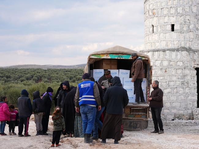 Displaced Syrians receive aid at a temporary camp in the village of al-Hamam in northwest Syria. Picture: AFP