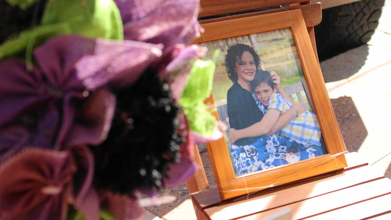 Catherine was an adoring mother to eight-year-old Peter Dunn, who helped set up the memorial display for his mother. Picture: Marian Faa