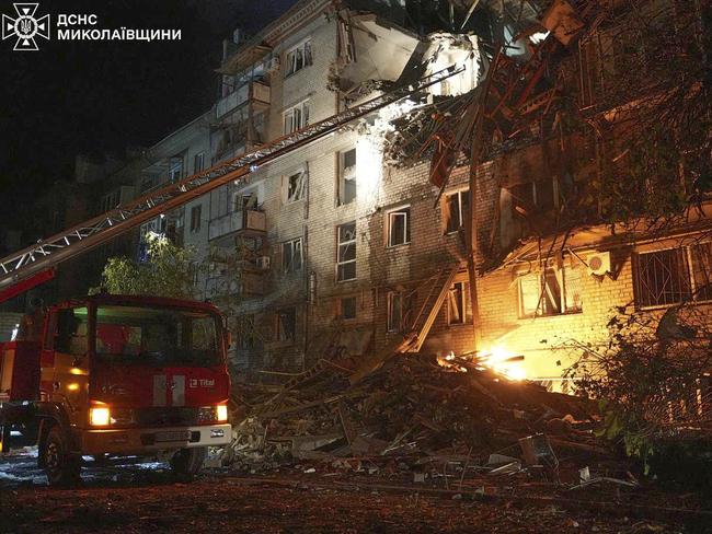 Firefighters try to put out a fire after Russia's drone hit a residential building in Mykolayiv, in southwest Ukraine on Sunday Picture: Ukrainian Emergency Service via AP)
