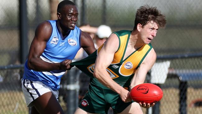 WRFL: Point Cook Centrals’ Kwar Ater tries to stop Cameron Morrison of Wyndhamvale. Picture: George Sal