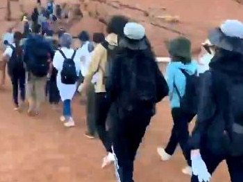 The video shows hundreds lining up before 7am to scale Uluru, which will be closed to climbers from Saturday.