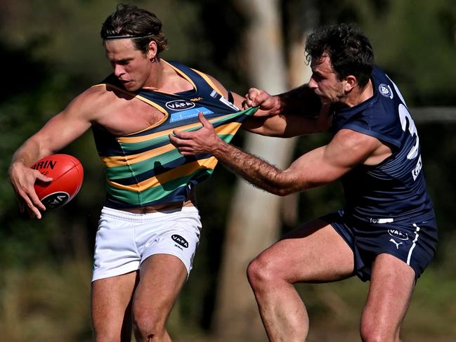 VAFA: St Kevin’s Josh Wallis gets a kick away under pressure. Picture: Andy Brownbill