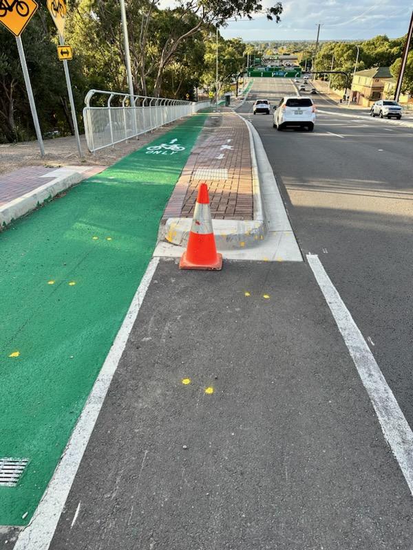 Changes have been made to the Flagstaff Rd, Darlington, bikeway blamed for the death last month of a cyclist. A concrete tripping hazard, pictured behind this warning cone, has been removed. Pictures: Frank Pangallo.,