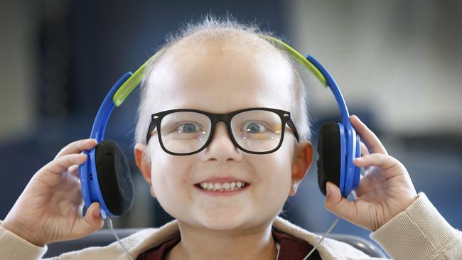 Benjamin Tadzic, 6, relaxes with some tunes on the oncology ward. Picture: David Caird