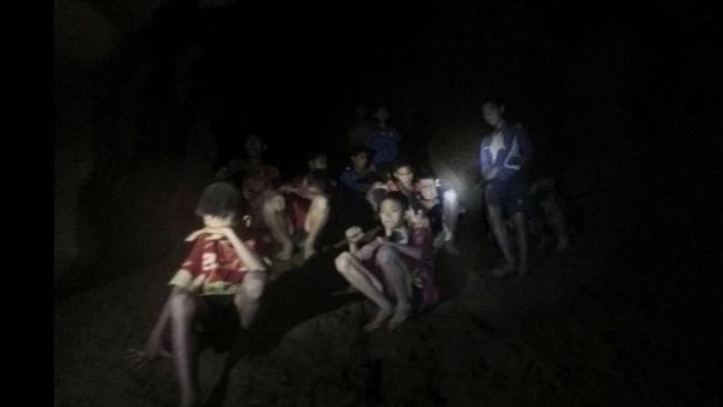 The boys and their coach as they were found in the partially flooded cave, thin and weak after nine days without food.