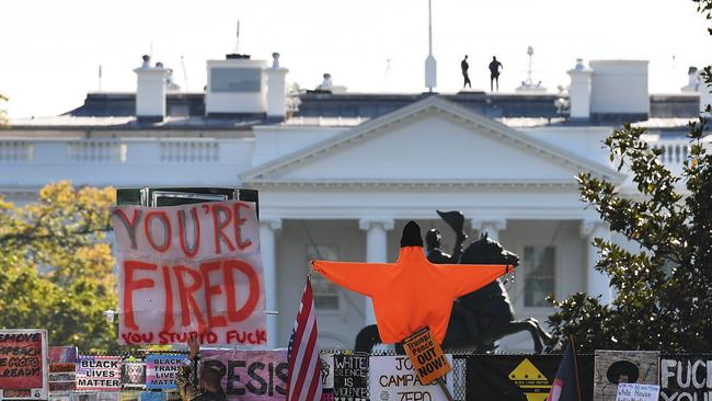 Placards decorate a fence surrounding Lafayette Square in front of the White House in Washington, DC on November 6. Picture: AFP
