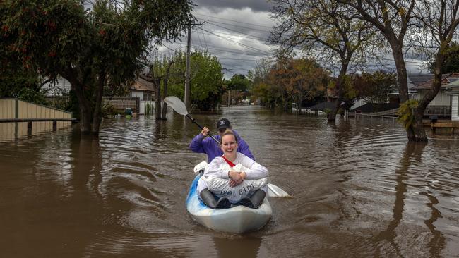 Two residents canoe down a flooded street in Maribyrnong. Picture: Getty Images