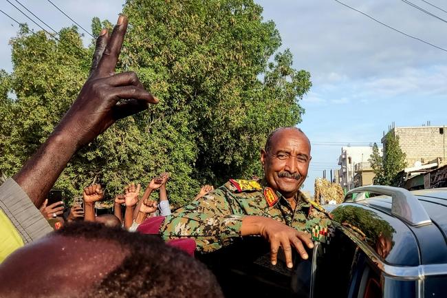 People cheer Sudan's de facto leader, armed forces chief Abdel Fattah al-Burhan, at the market in Port Sudan on December 29, 2024