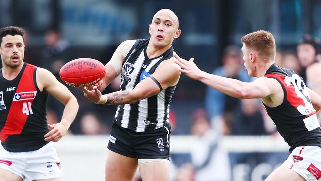 Alex Woodward gets away a handball in the VFL elimination final against the Dons.