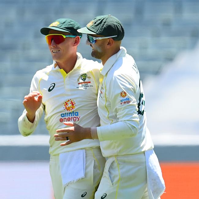 Marnus Labuschagne and Nathan Lyon celebrate his catch to remove Khaya Zondo.