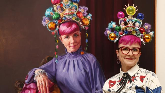 Cal Wilson posing beside Andrea Huelin's Packing Room Prize 2023 portrait of her titled 'Clown Jewels' in early 2023. Picture: Don Arnold/WireImage