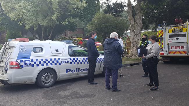 Investigators gather outside the scene of a house fire in Hunter Ct, Ringwood East on July 29, 2020. Picture: Kiel Egging.