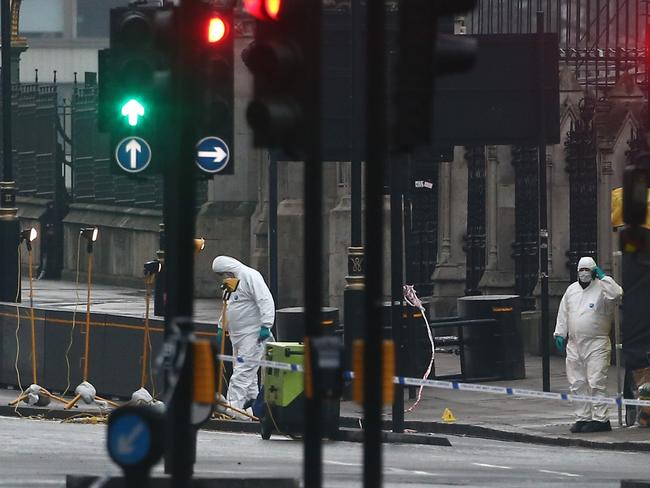 Forensics investigators and police officers work near Westminster Bridge. Picture: Reuters